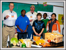 Wake County Farm Bureau members Richard Jenks, left, and Jay Thompson visit with students at Leesville Road Middle School on Career Day. 
