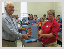 Gaston County Farm Bureau President Bill Craig presents a The Farmer Grows a Rainbow Kit during a teacher workshop in August.