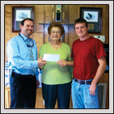 Duplin County Farm Bureau Women’s Committee Chair Eva Ketelsleger, center, presents a check to Lee Graham, left, and David Kilpatrick, right, of the Kenansville Fire Department. 