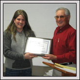 UNION COUNTY Farm Bureau Member Farrah Hargett, left, received a plaque from NCFB Executive Vice President Elton Braswell for her service as Young Farmers & Ranchers Chair and State Board Member in 2009.