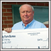 Farm Bureau President Thomas Shaw displays the $125,000 check that was presented to the county for a new Vance County Regional Farmers’ Market.